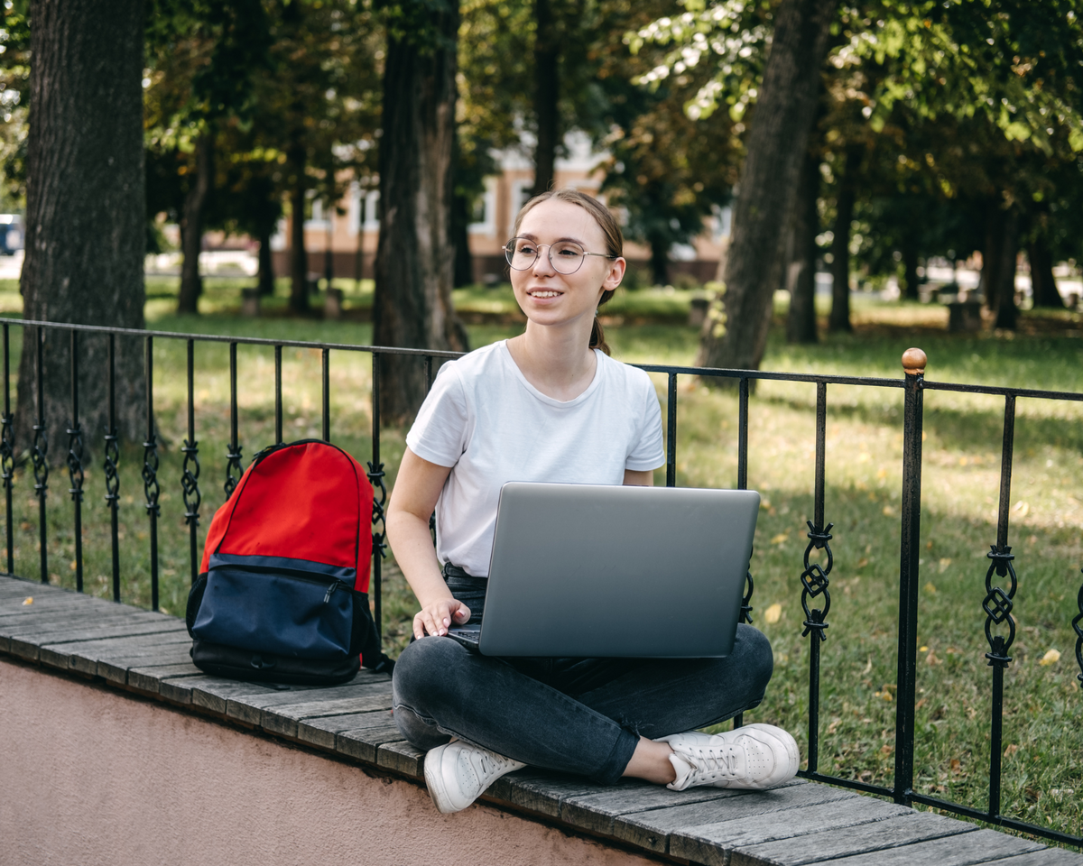 Girl on a computer at a park