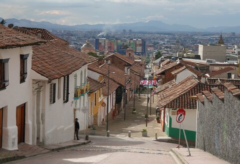houses flank an empty street leading into Bogota