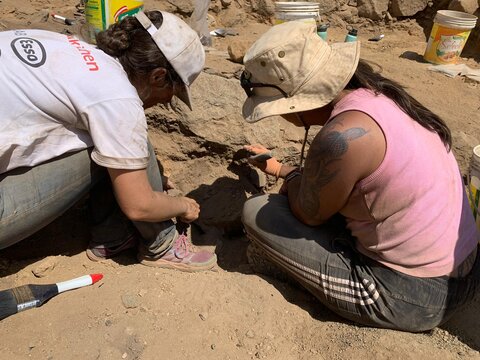 Instructor and student at dig site in Peru