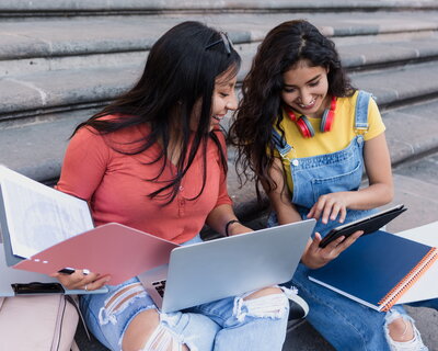 Two students looking at a tablet